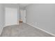 Clean bedroom featuring plush neutral carpet, white trim, and a closet at 4298 Campsite Loop, Orlando, FL 32824