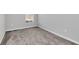 Cozy bedroom with neutral carpet, white trim, and ample natural light from a single window at 4298 Campsite Loop, Orlando, FL 32824