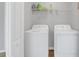 Convenient laundry room with washer, dryer, and shelving at 4298 Campsite Loop, Orlando, FL 32824