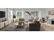 Bright living room featuring modern decor, wood floors, and sliding glass doors to a screened patio at 4298 Campsite Loop, Orlando, FL 32824