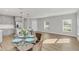 Bright living space with wood floors, kitchen with stainless steel appliances, and a glass dining table at 4298 Campsite Loop, Orlando, FL 32824