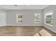 Bright room with wood floors, two windows, and a door; neutral walls ready for personalization at 4298 Campsite Loop, Orlando, FL 32824