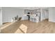 Open-concept living space with wood floors, kitchen with stainless steel appliances, and a dining area at 4298 Campsite Loop, Orlando, FL 32824