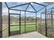 Relaxing screened patio overlooking a pond and lush landscape at 4298 Campsite Loop, Orlando, FL 32824