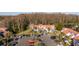 Aerial view of a townhome complex with a tile roof, reserved parking, and mature landscaping at 4765 Capri Pl # 209, Orlando, FL 32811