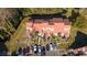 Aerial view of two-story townhomes with tile roofs and reserved parking spaces at 4765 Capri Pl # 209, Orlando, FL 32811