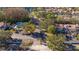 Aerial view of community pool and townhomes with tile roofs surrounded by landscaping at 4765 Capri Pl # 209, Orlando, FL 32811