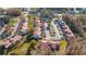 Aerial view of townhomes featuring tile roofs, lush landscaping, and convenient parking at 4765 Capri Pl # 209, Orlando, FL 32811