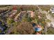 Aerial view of condo community with assigned parking, pond, and community pool at 4765 Capri Pl # 209, Orlando, FL 32811