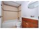 Bathroom view includes a tub with tile surround and a vanity with dark wood cabinets at 4765 Capri Pl # 209, Orlando, FL 32811