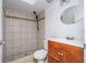 Cozy bathroom includes a vanity with a sink, toilet, and shower with tile surround at 4765 Capri Pl # 209, Orlando, FL 32811