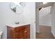 Bathroom view includes a vanity with dark wood cabinets and an ornate mirror on the white wall at 4765 Capri Pl # 209, Orlando, FL 32811
