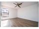 Bedroom with ceiling fan, wood floors, window, and closet for ample storage at 4765 Capri Pl # 209, Orlando, FL 32811
