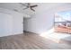 Bedroom with wood floors, ceiling fan, window, and closets for storage at 4765 Capri Pl # 209, Orlando, FL 32811