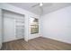 Bright bedroom features a ceiling fan, wood floors, window, and walk-in closet at 4765 Capri Pl # 209, Orlando, FL 32811