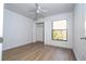 Light and bright bedroom includes a ceiling fan, a closet, and a window with a wooded view at 4765 Capri Pl # 209, Orlando, FL 32811