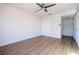 Bright bedroom with wood-look floors, ceiling fan, and closet with white doors at 4765 Capri Pl # 209, Orlando, FL 32811