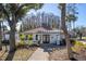 Community clubhouse with tiled roof and palm tree in foreground at 4765 Capri Pl # 209, Orlando, FL 32811