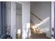 Bright entryway featuring wood-look flooring, stairs, coat closet, and natural light at 4765 Capri Pl # 209, Orlando, FL 32811