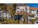 Charming townhome featuring a tile roof, decorative windows and gate, and mature landscaping at 4765 Capri Pl # 209, Orlando, FL 32811