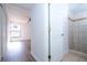 Hallway leads to bedroom and bathroom with tiled shower and modern fixtures at 4765 Capri Pl # 209, Orlando, FL 32811