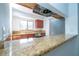 Open kitchen view showcases granite countertops, stainless steel appliances, and ample counter space at 4765 Capri Pl # 209, Orlando, FL 32811