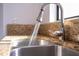 Stainless steel kitchen sink with granite countertop and pull-down faucet at 4765 Capri Pl # 209, Orlando, FL 32811