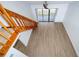 Bright living room features wood-look floors, sliding glass doors to a balcony, and an attractive staircase at 4765 Capri Pl # 209, Orlando, FL 32811