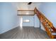 Open living area with loft, staircase, and pass through to the kitchen at 4765 Capri Pl # 209, Orlando, FL 32811