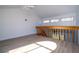Loft area with railing overlooking the living room and three windows at 4765 Capri Pl # 209, Orlando, FL 32811