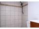 Shower features tile surround, showerhead, and is positioned next to the toilet at 4765 Capri Pl # 209, Orlando, FL 32811