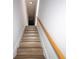 Stairway with wood-look steps and light wood railing at 4765 Capri Pl # 209, Orlando, FL 32811