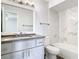 Updated bathroom with marble-look tile and gray vanity at 5144 Conroy Rd # 35, Orlando, FL 32811