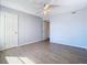 Well-lit bedroom with wood-look floors and ample closet space at 5144 Conroy Rd # 35, Orlando, FL 32811