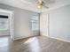 Bedroom with wood-look floors and large windows at 5144 Conroy Rd # 35, Orlando, FL 32811