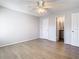 The bedroom features wood-look floors, a ceiling fan, and ensuite bathroom at 5144 Conroy Rd # 35, Orlando, FL 32811
