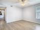 Bright bedroom with ceiling fan and wood-look floors at 5144 Conroy Rd # 35, Orlando, FL 32811