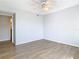 Bright bedroom with ceiling fan and laminate wood floors at 5144 Conroy Rd # 35, Orlando, FL 32811