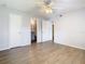 Primary bedroom with bathroom access and wood-look floors at 5144 Conroy Rd # 35, Orlando, FL 32811