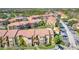 Two-story building with Spanish-style tile roof and landscaping at 5144 Conroy Rd # 35, Orlando, FL 32811