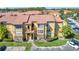 Two-story building with Spanish-style tile roof and landscaping at 5144 Conroy Rd # 35, Orlando, FL 32811