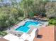 Resort-style pool with a playground and surrounding lush landscaping at 5144 Conroy Rd # 35, Orlando, FL 32811