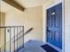 Condo building entry with blue door and security system at 5144 Conroy Rd # 35, Orlando, FL 32811
