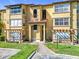 Inviting condo building exterior with attractive landscaping and architectural details at 5144 Conroy Rd # 35, Orlando, FL 32811