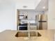 Modern condo kitchen with stainless steel appliances and light gray cabinets at 5144 Conroy Rd # 35, Orlando, FL 32811