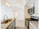 Modern condo kitchen with stainless steel appliances and light gray cabinets at 5144 Conroy Rd # 35, Orlando, FL 32811