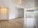 Bright living room with wood-look tile flooring and large windows offering natural light at 5144 Conroy Rd # 35, Orlando, FL 32811