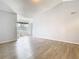Bright living room with wood-look floors and large window at 5144 Conroy Rd # 35, Orlando, FL 32811