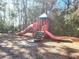 Outdoor playground featuring a slide and climbing structure in a wooded setting at 5144 Conroy Rd # 35, Orlando, FL 32811