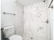 Large walk-in shower with marble tile and pebble floor at 5144 Conroy Rd # 35, Orlando, FL 32811